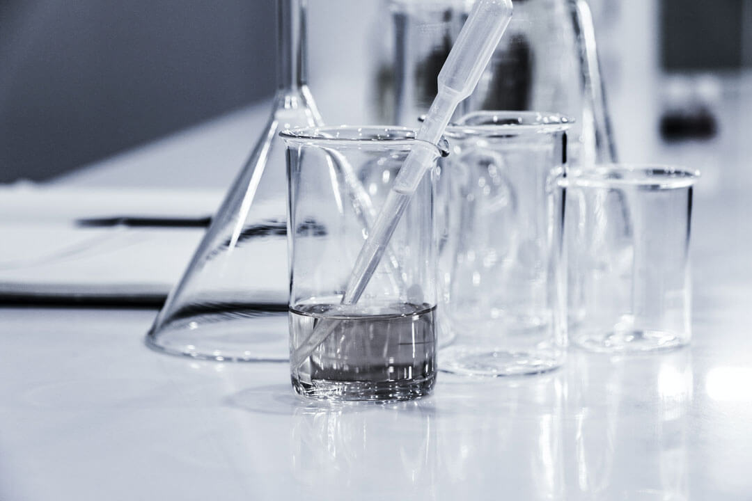 Glass beakers sitting on table.